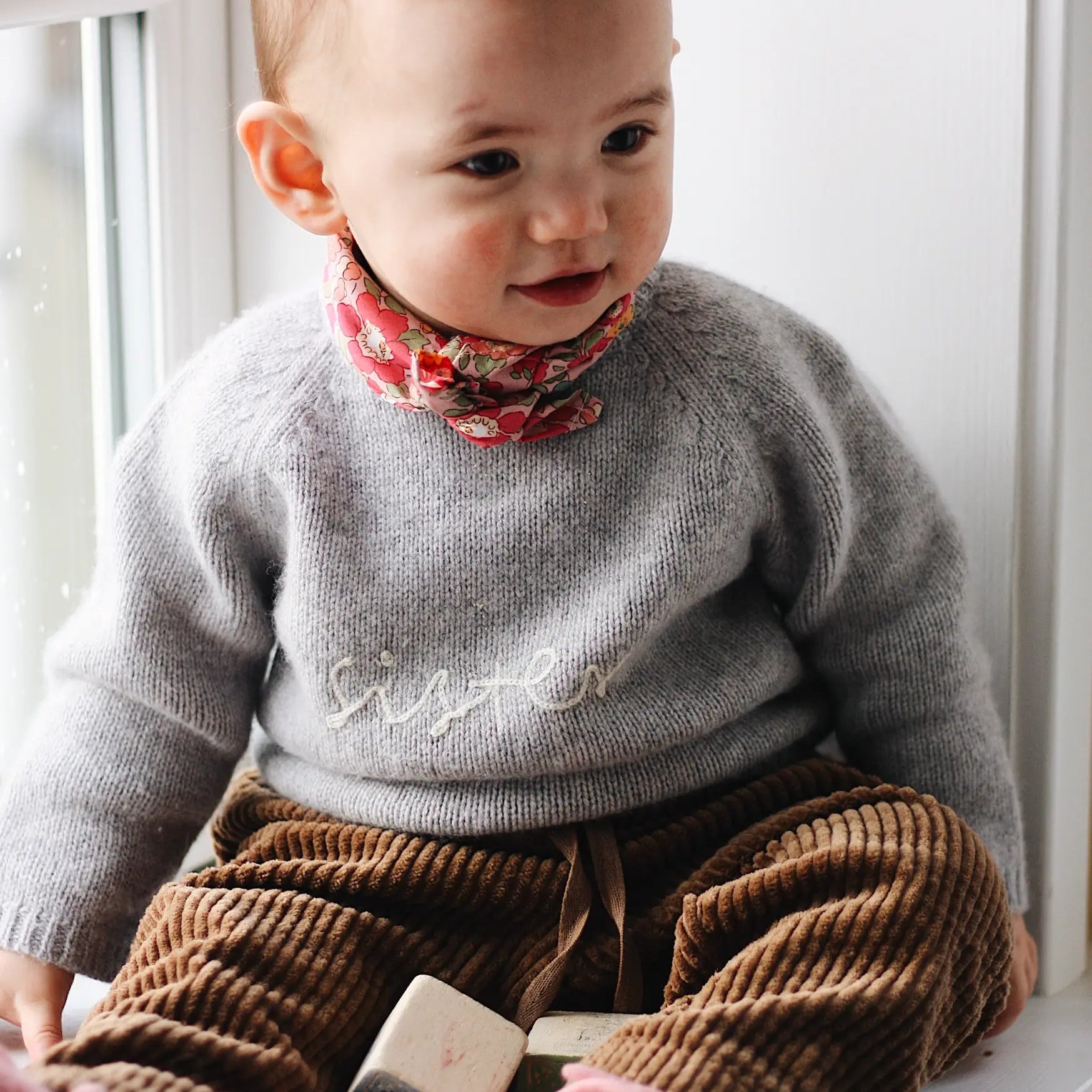 Baby girl wearing Lalaby Alpha shoes in sorbet pink cashmere
