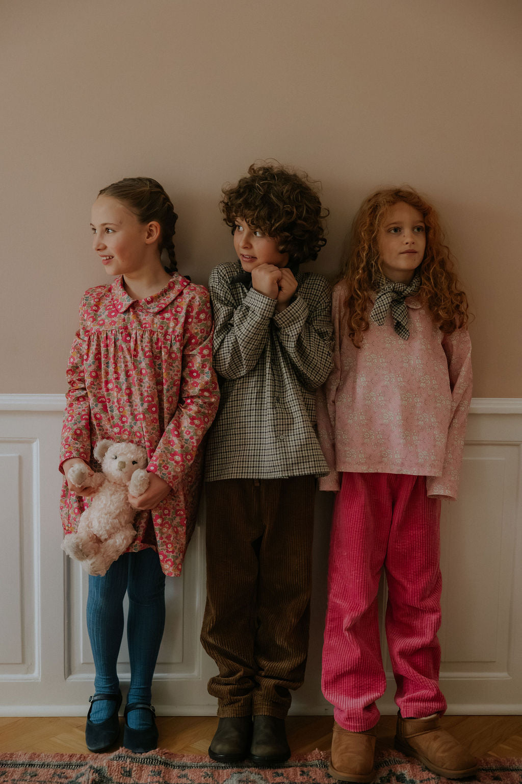 Girl wearing Lalaby Anna dress for kids in berry betsy pink liberty organic cotton