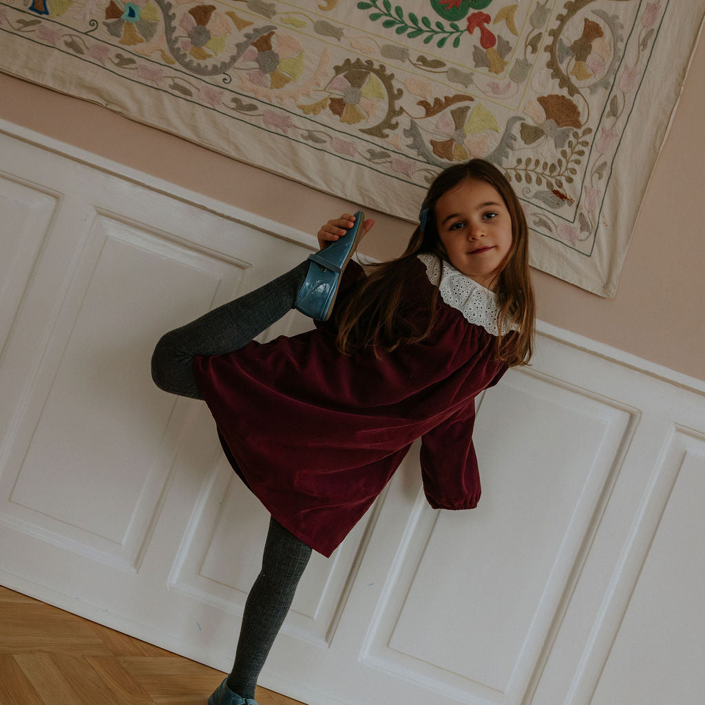 Girl wearing Lalaby Annabella dress for kids in ruby red cotton baby cord