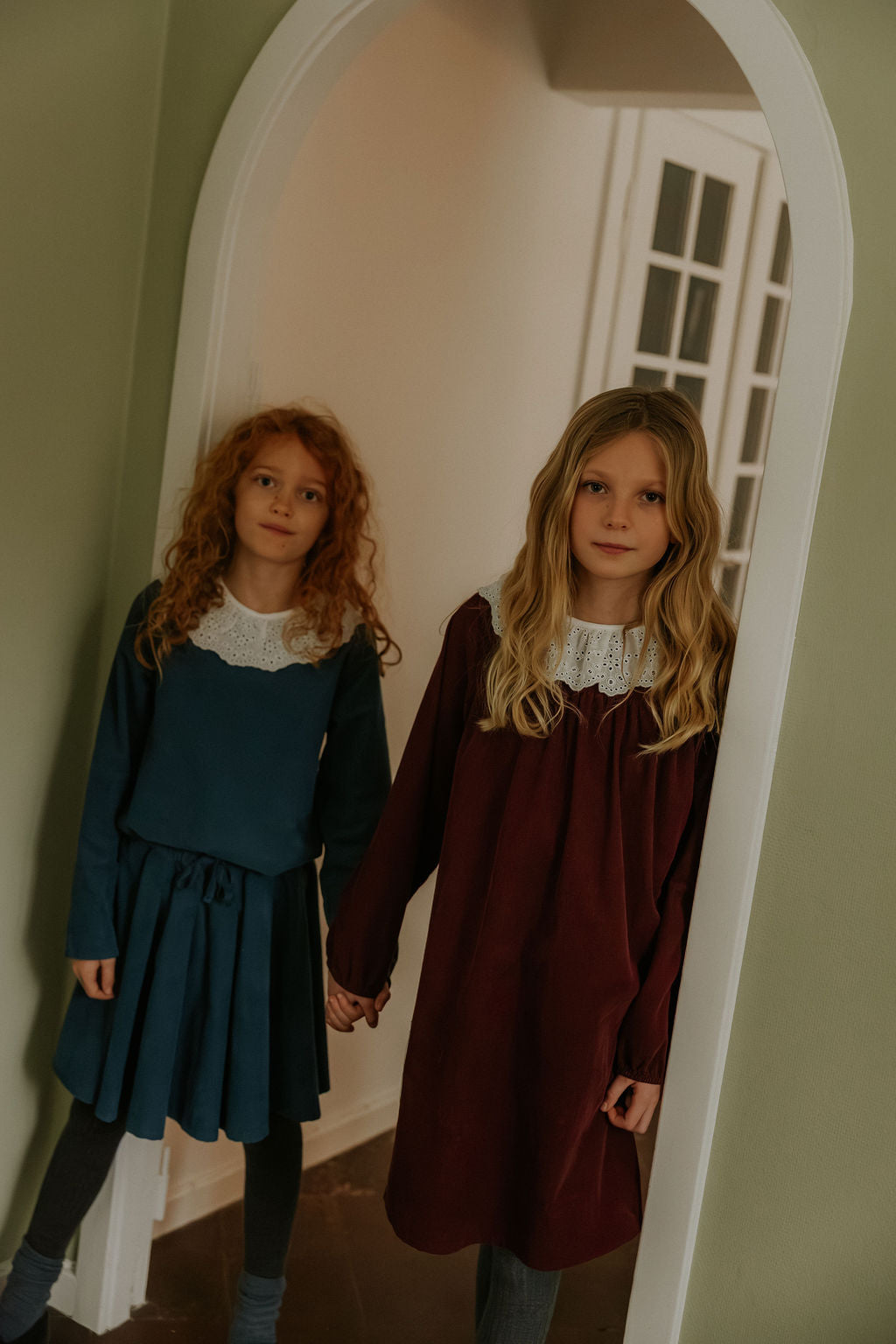 Girl wearing Lalaby Annabella dress for kids in ruby red cotton baby cord