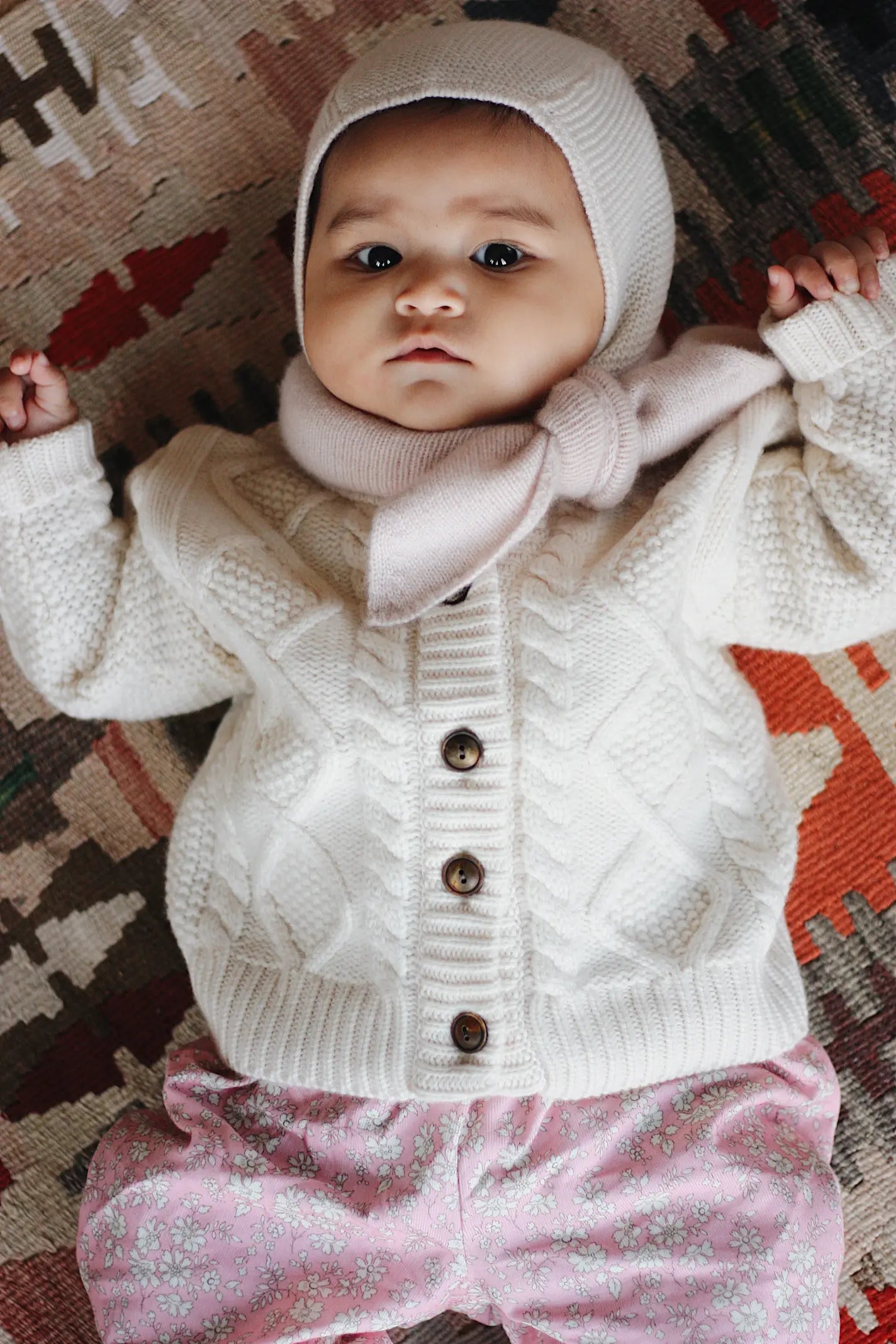 Baby girl wearing Lalaby Atlas scarf for babies, kids and adults in powder pink cashmere