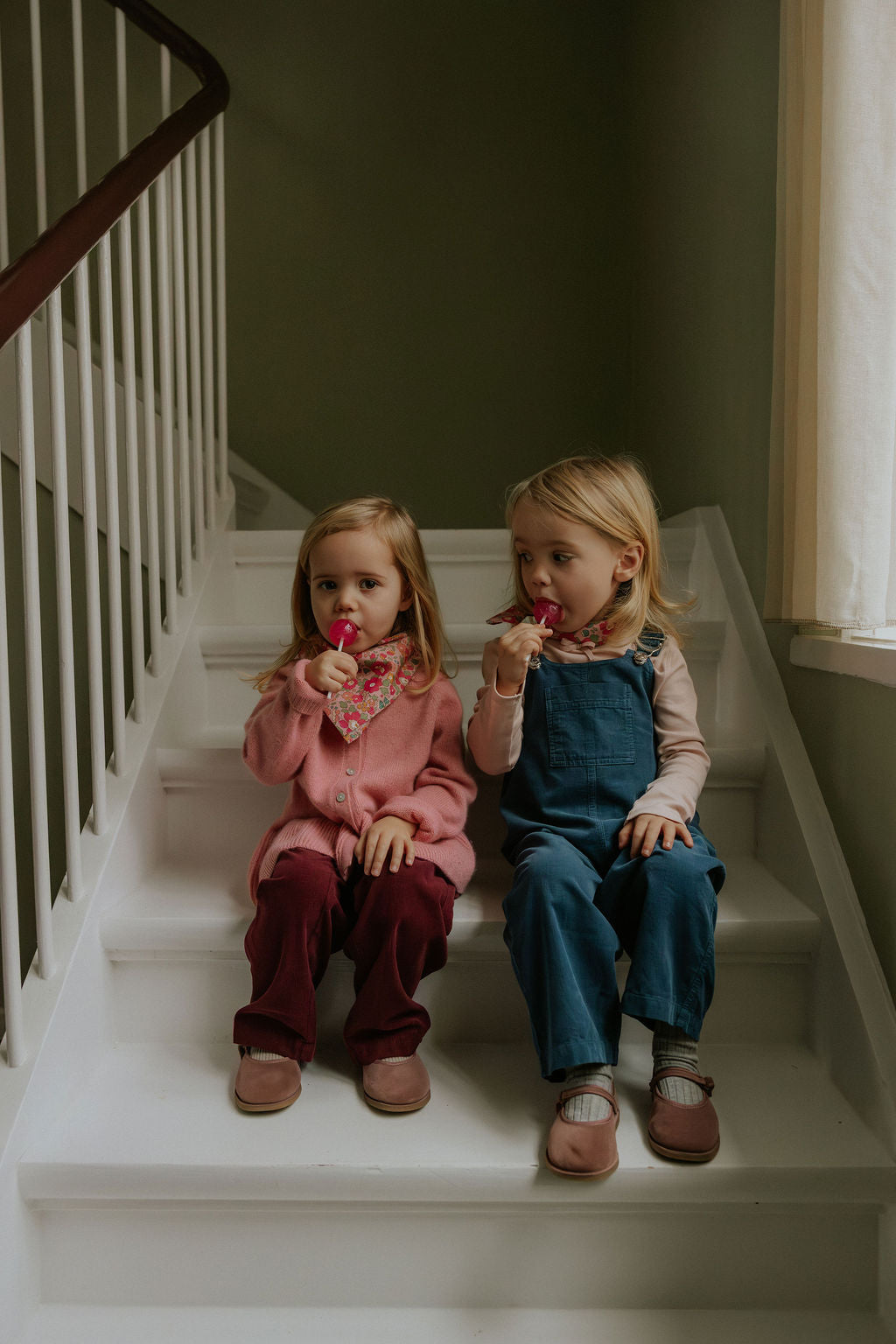 Girl wearing Lalaby Axel trousers for kids in ruby red cotton baby cord
