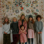 Boy wearing Lalaby Axel trousers for kids in ruby red cotton baby cord