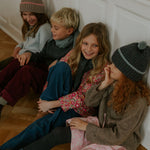 Boy wearing Lalaby Axel trousers for kids in ruby red cotton baby cord