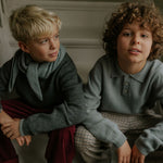 Boy wearing Lalaby Axel trousers for kids in ruby red cotton baby cord