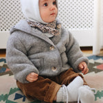 Baby boy wearing Lalaby Babar baby jacket in elephant grey merino wool
