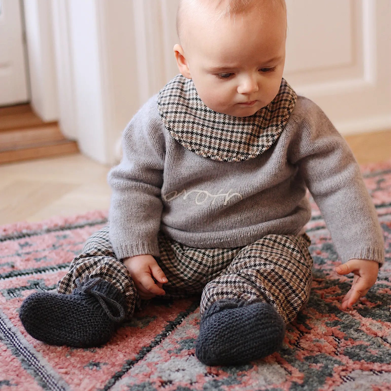 Baby boy wearing tweedy check organic cotton bib from Lalaby Bibi bib 2-pack