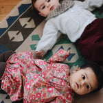 Baby wearing Lalaby Bobbie cardigan in bluey light blue cashmere