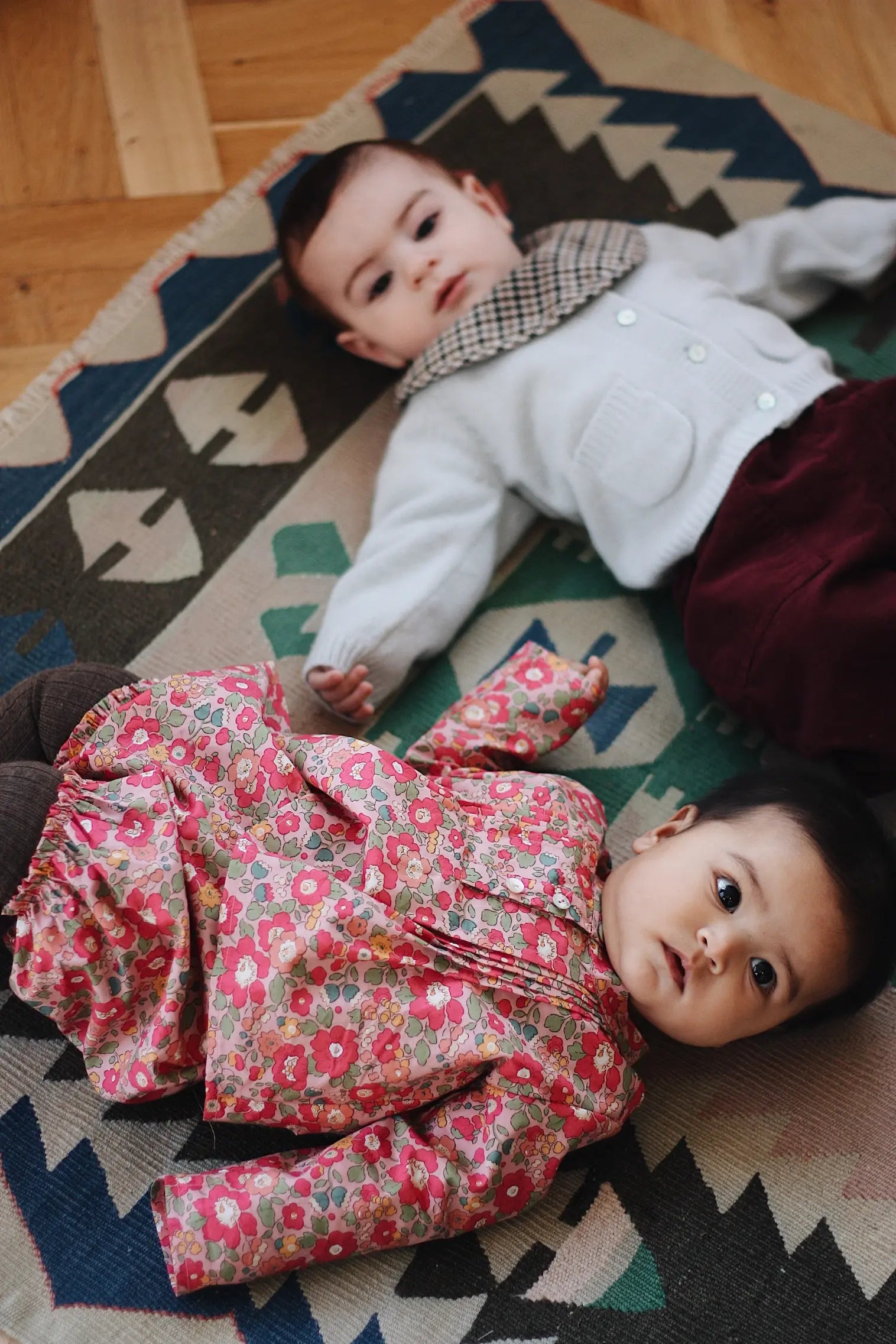 Baby wearing Lalaby Bobbie cardigan in bluey light blue cashmere