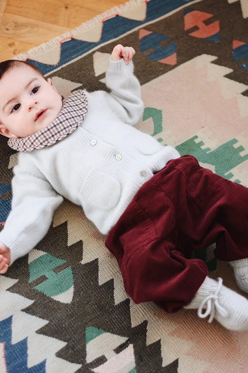 Baby boy wearing Lalaby Bobbie baby cardigan in bluey light blue cashmere
