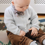 Baby boy wearing Lalaby Bobbie baby cardigan in bluey light blue cashmere
