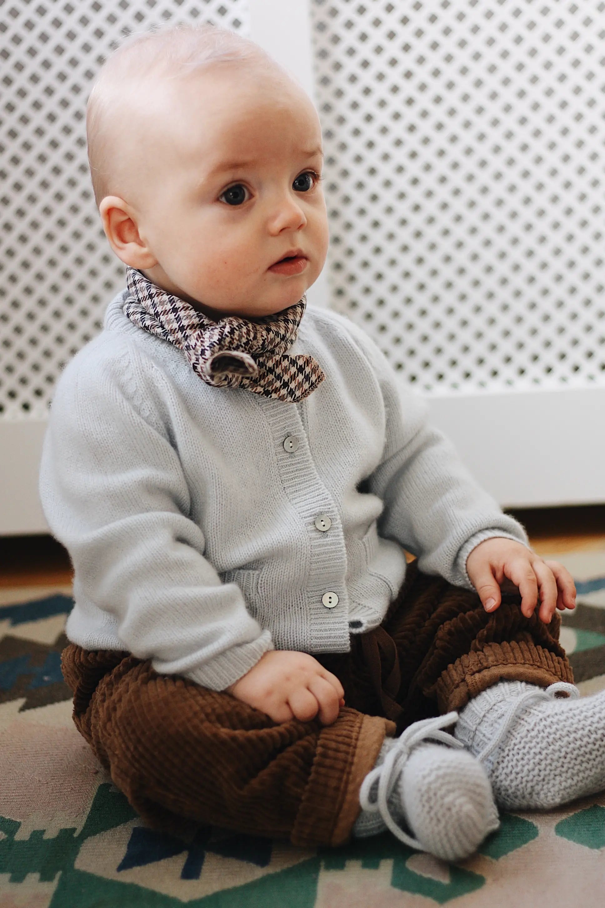 Baby boy wearing Lalaby Bobbie baby cardigan in bluey light blue cashmere