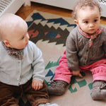 Baby boy wearing Lalaby Bobbie baby cardigan in bluey light blue cashmere