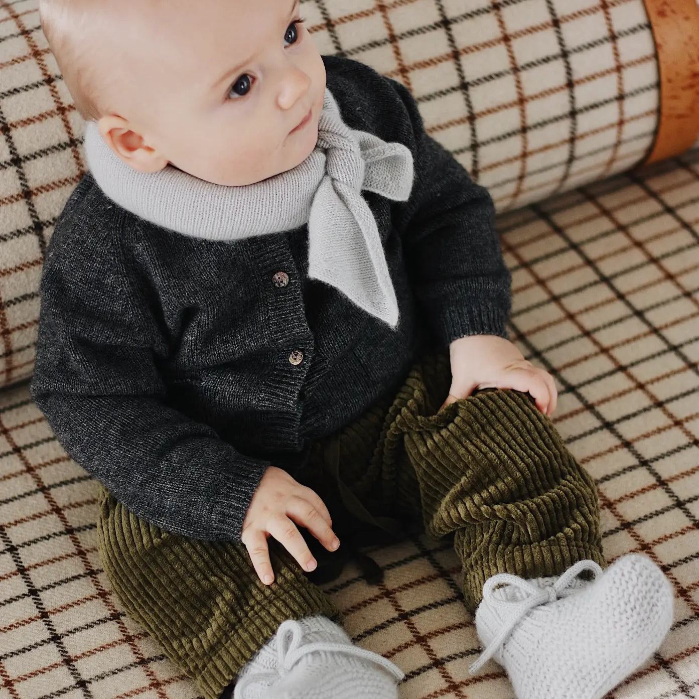 Baby wearing Lalaby Bobbie cardigan in storm grey cashmere