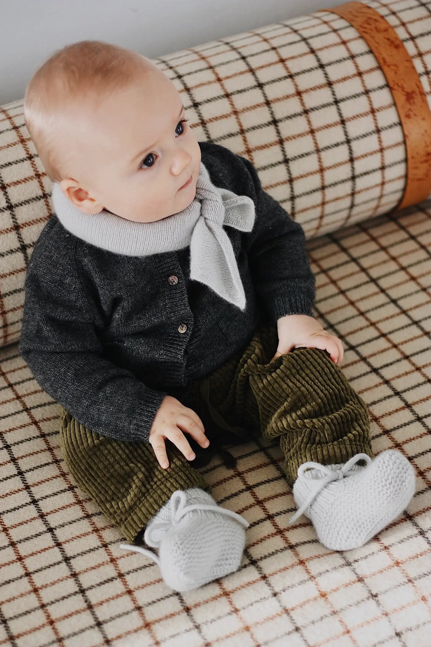 Baby wearing Lalaby Bobbie cardigan in storm grey cashmere