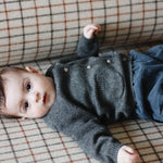 Baby boy wearing Lalaby Bobbie baby cardigan in storm grey cashmere