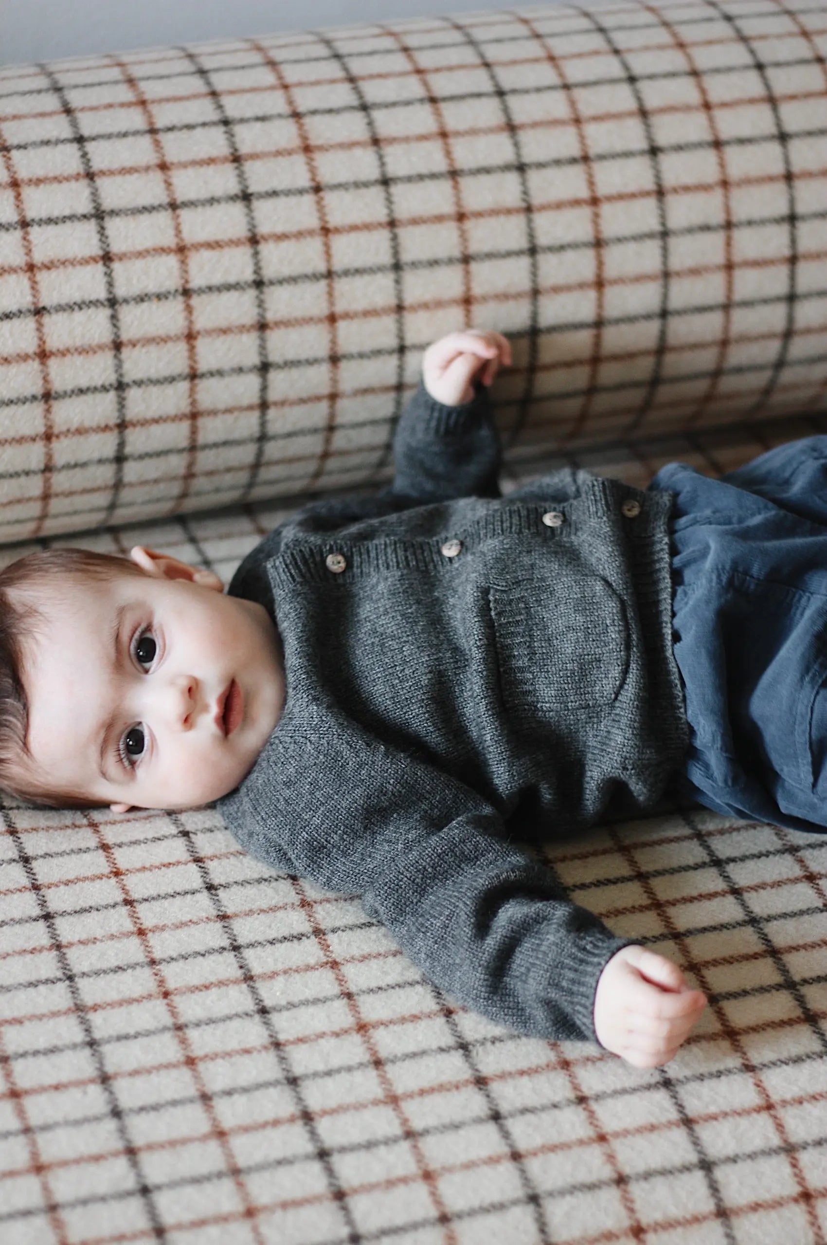 Baby boy wearing Lalaby Bobbie baby cardigan in storm grey cashmere