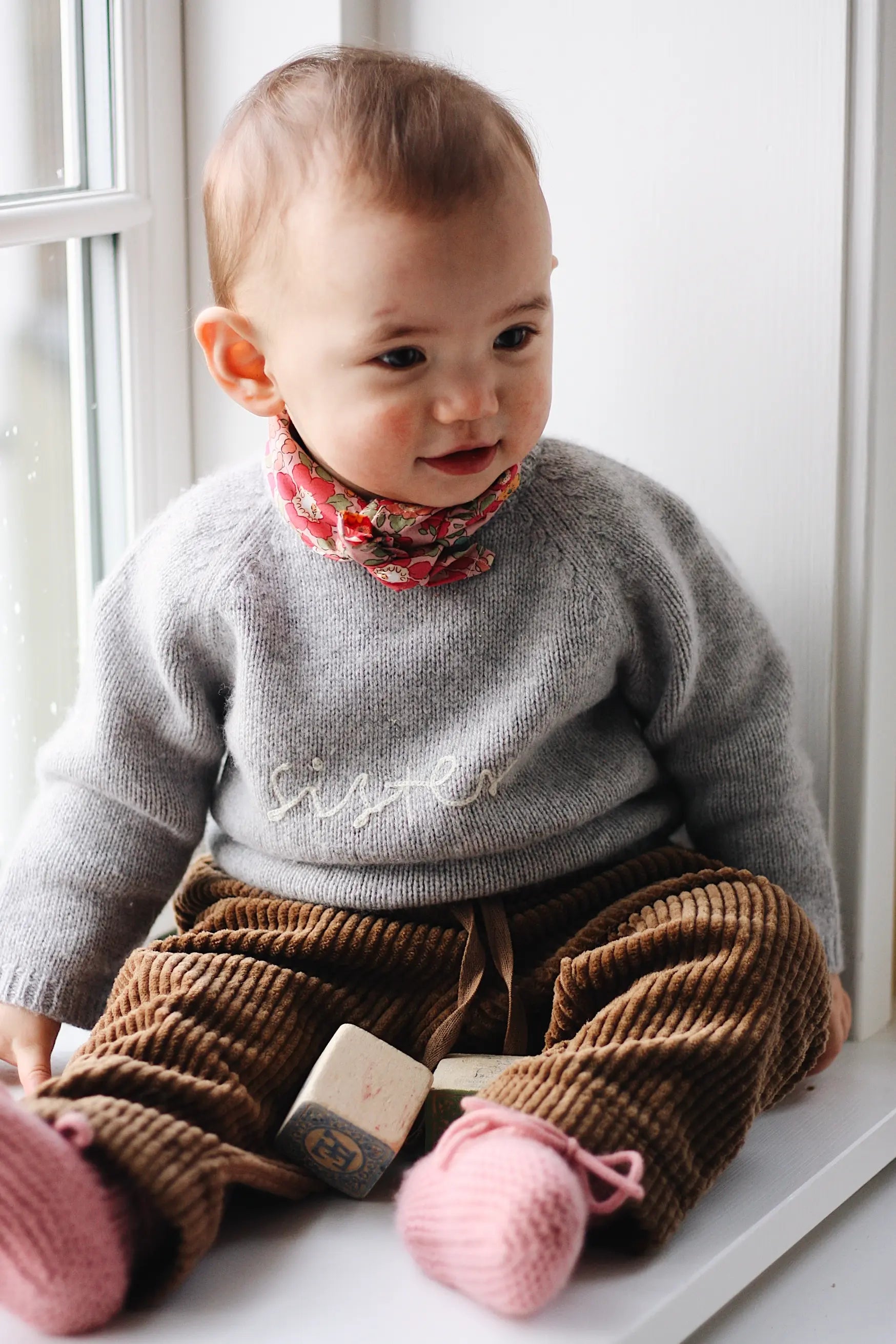 Baby girl wearing Lalaby Charlie baby trousers in cookie brown cotton mega corduroy