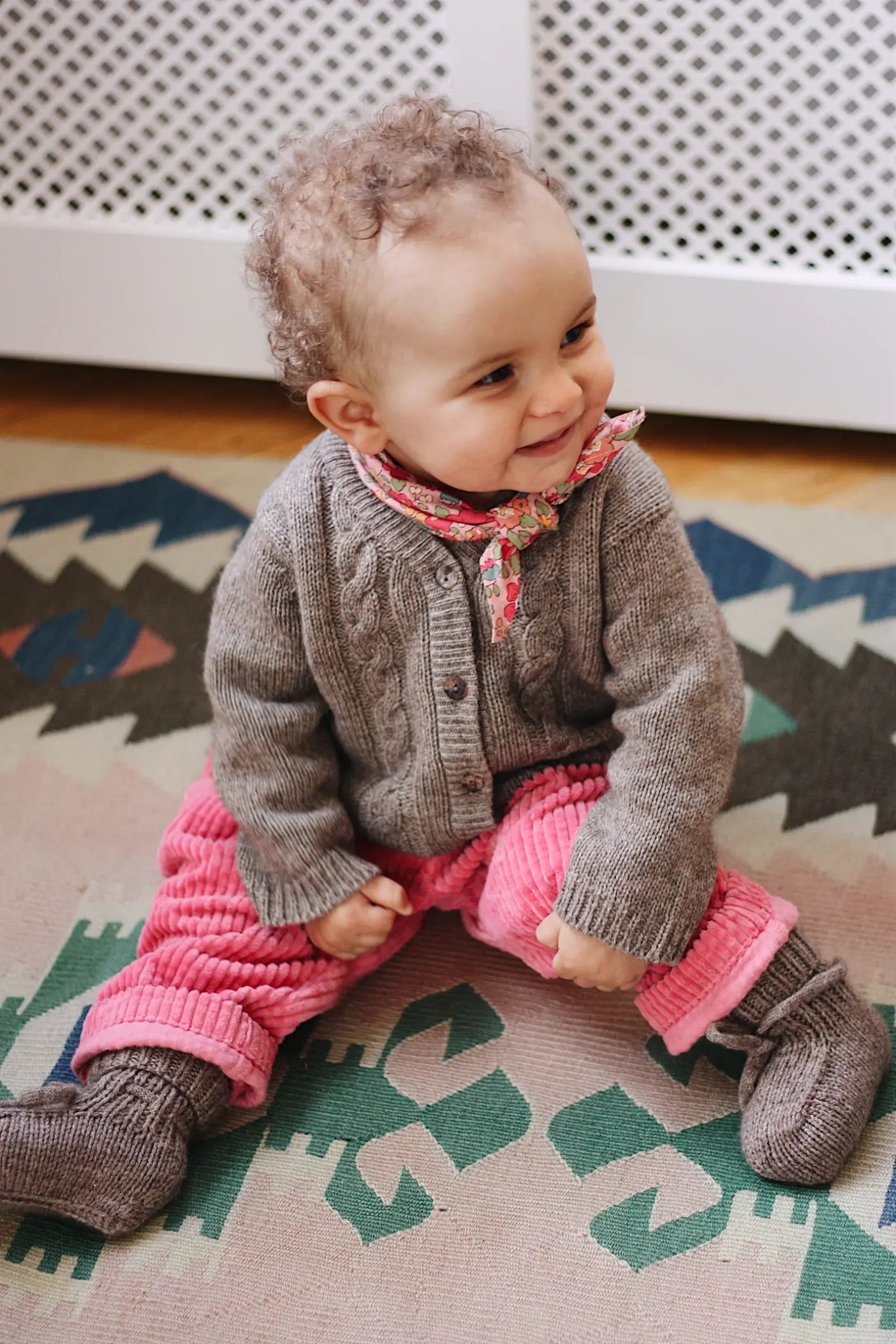 Baby girl wearing Lalaby Charlie baby trousers in flamingo pink cotton mega corduroy