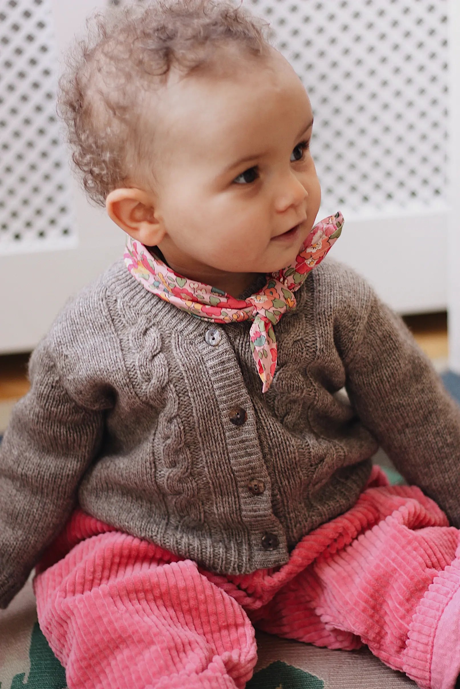 Baby girl wearing Lalaby Charlie baby trousers in flamingo pink cotton mega corduroy