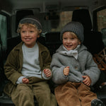 Boy wearing Lalaby Charlie trousers for kids in cookie brown organic cotton mega cord