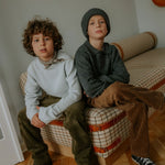 Boy wearing Lalaby Charlie trousers for kids in cookie brown organic cotton mega cord