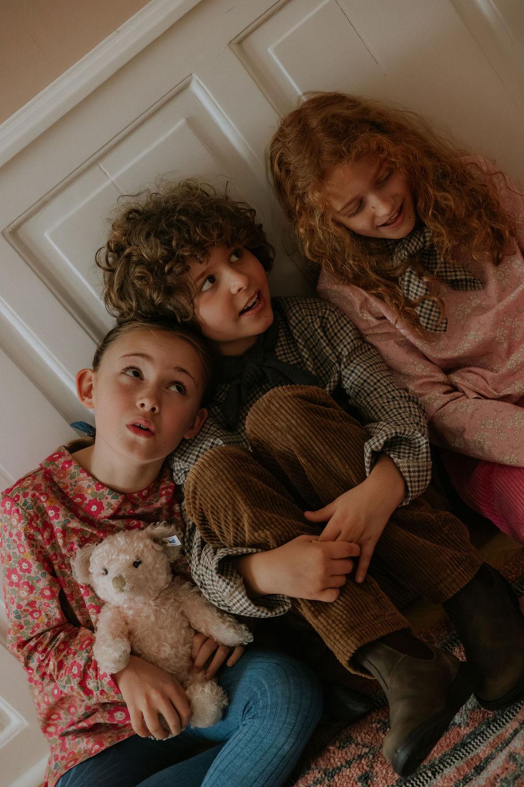 Boy wearing Lalaby Charlie trousers for kids in cookie brown organic cotton mega cord