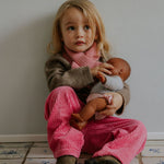 Girl wearing Lalaby Charlie trousers for kids in flamingo pink organic cotton mega cord