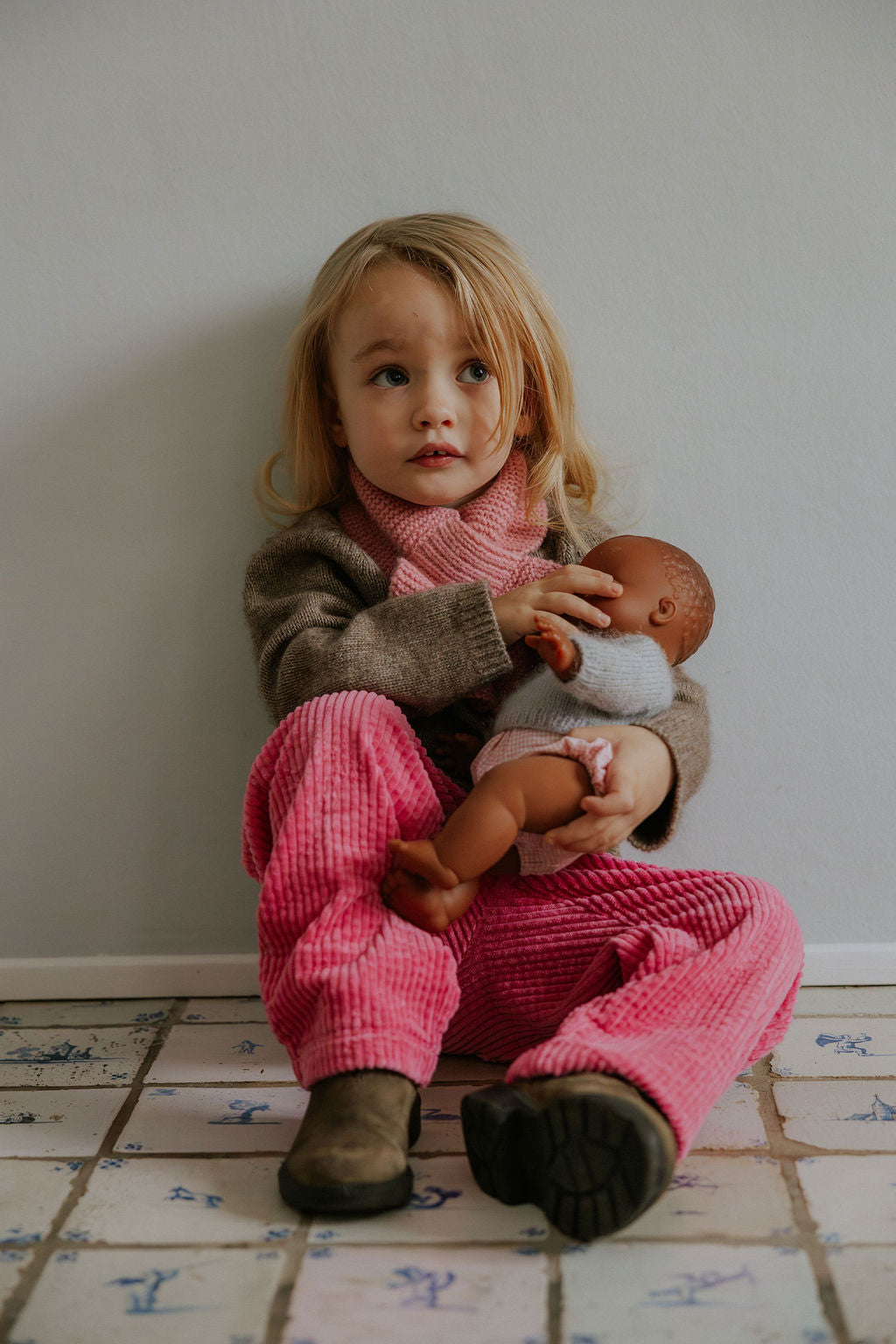 Girl wearing Lalaby Charlie trousers for kids in flamingo pink organic cotton mega cord