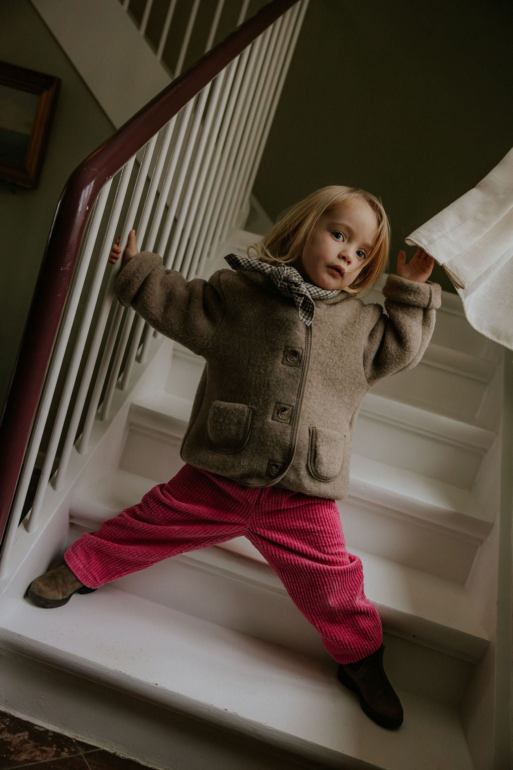 Girl wearing Lalaby Charlie trousers for kids in flamingo pink organic cotton mega cord