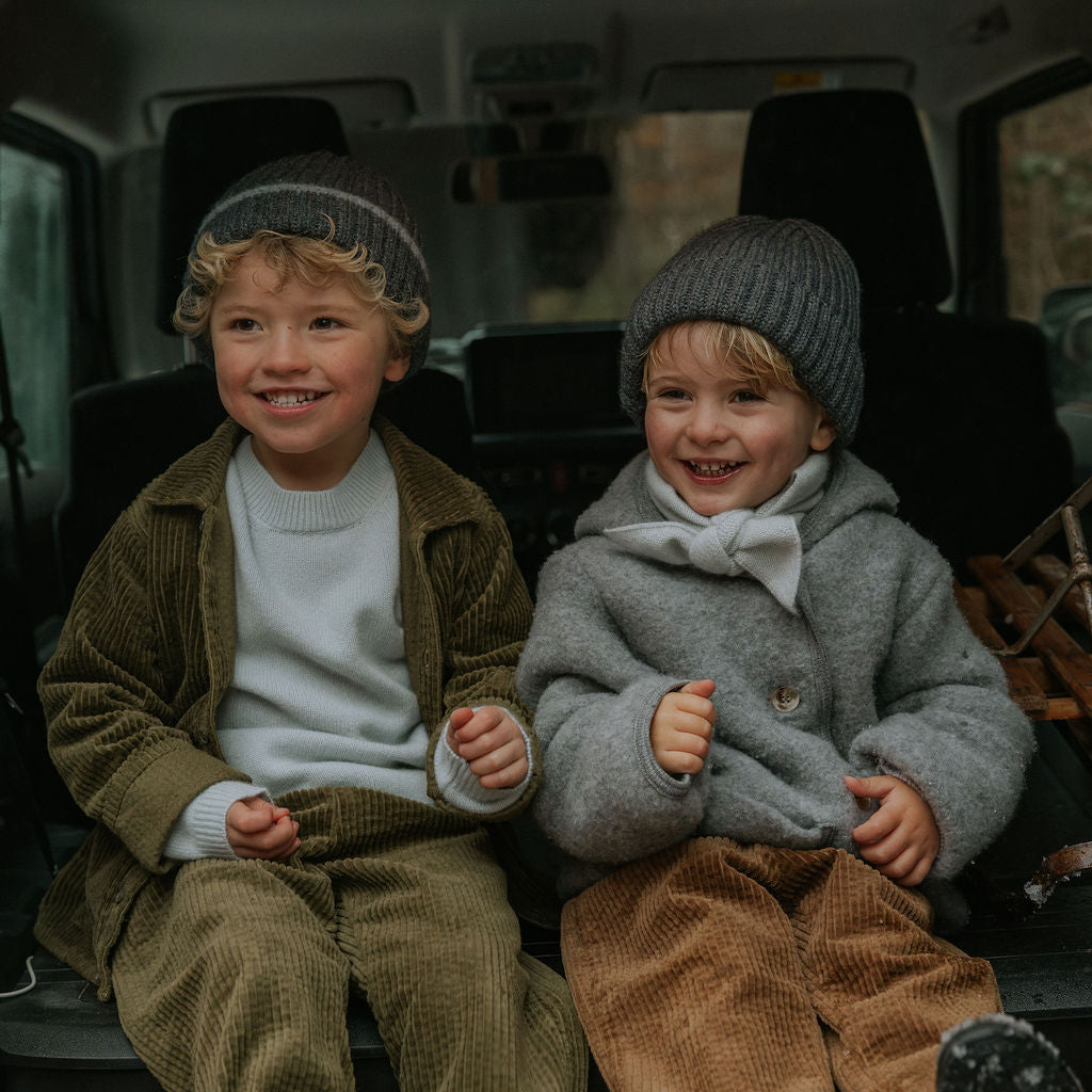 Boy wearing Lalaby Charlie kids trousers in forest green organic cotton mega cord