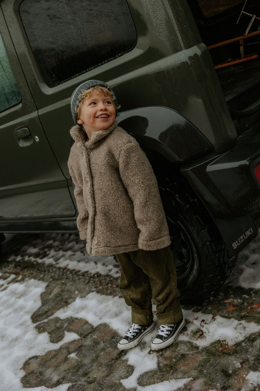Boy wearing Lalaby Charlie kids trousers in forest green organic cotton mega cord