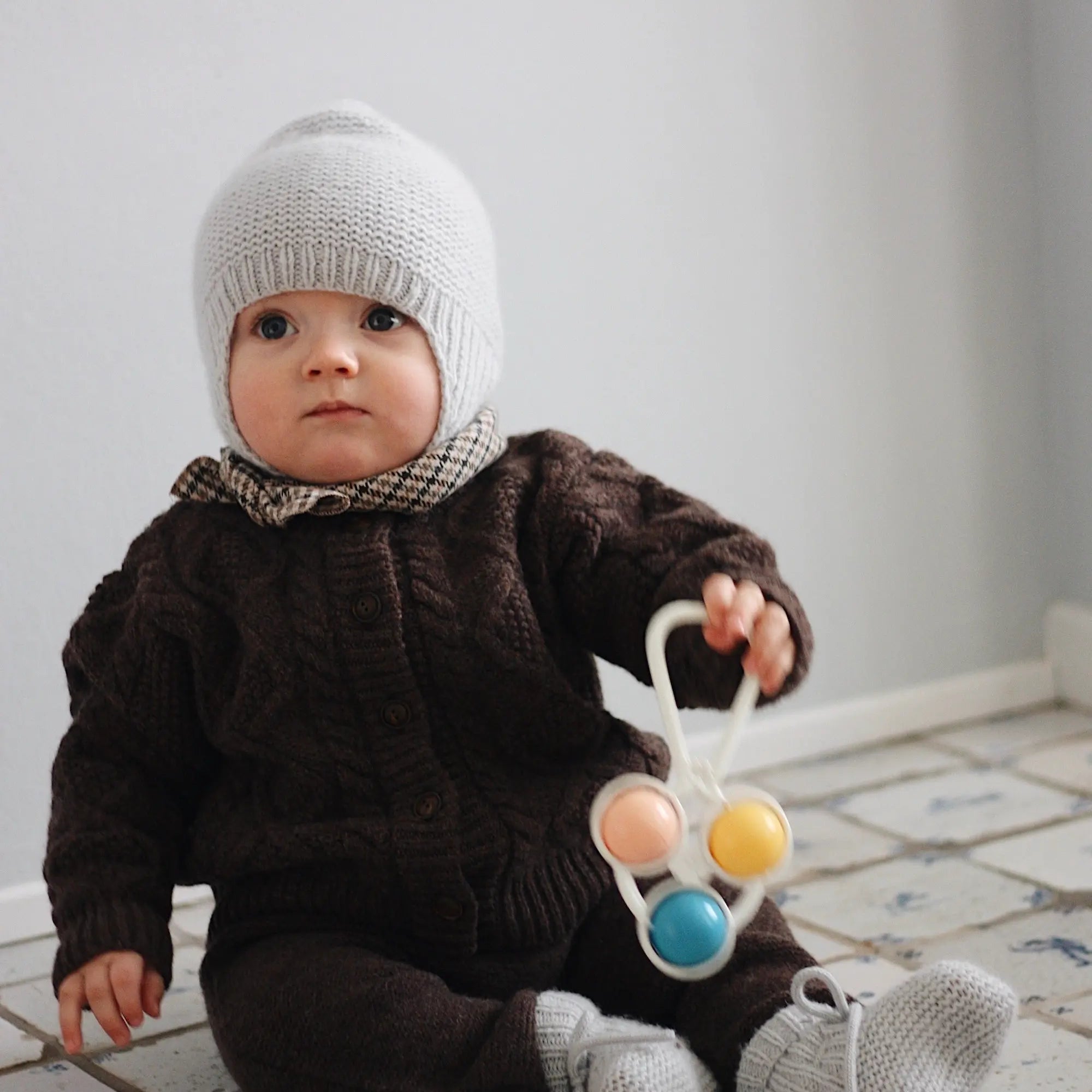 Baby boy wearing Lalaby Coby cardigan and Suri pants for babies in chocolate brown merino wool