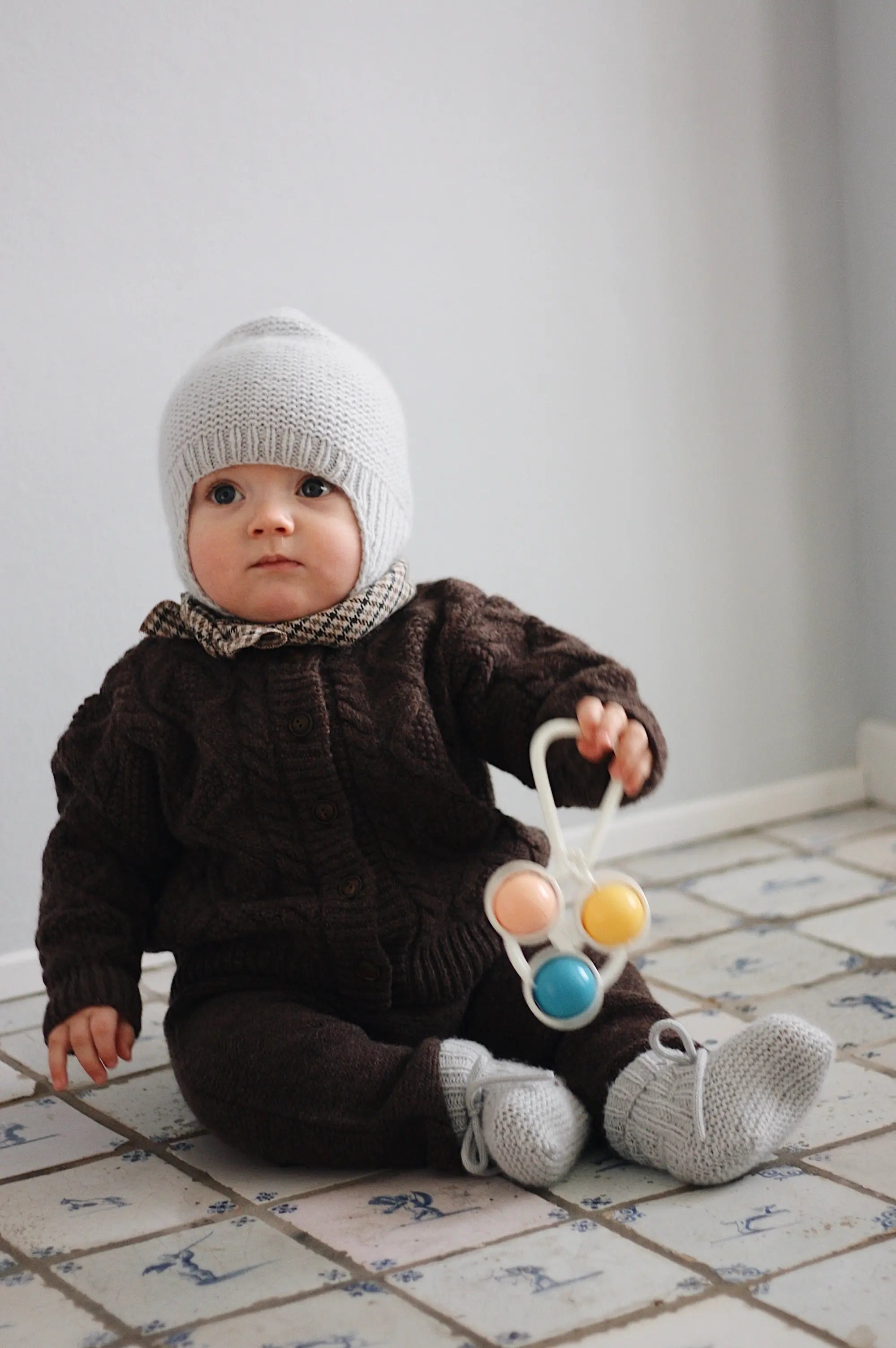 Baby boy wearing Lalaby Coby cardigan and Suri pants for babies in chocolate brown merino wool