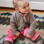 Baby girl wearing Lalaby Cony baby shoes in a millet brown baby wool, yak and cashmere blend