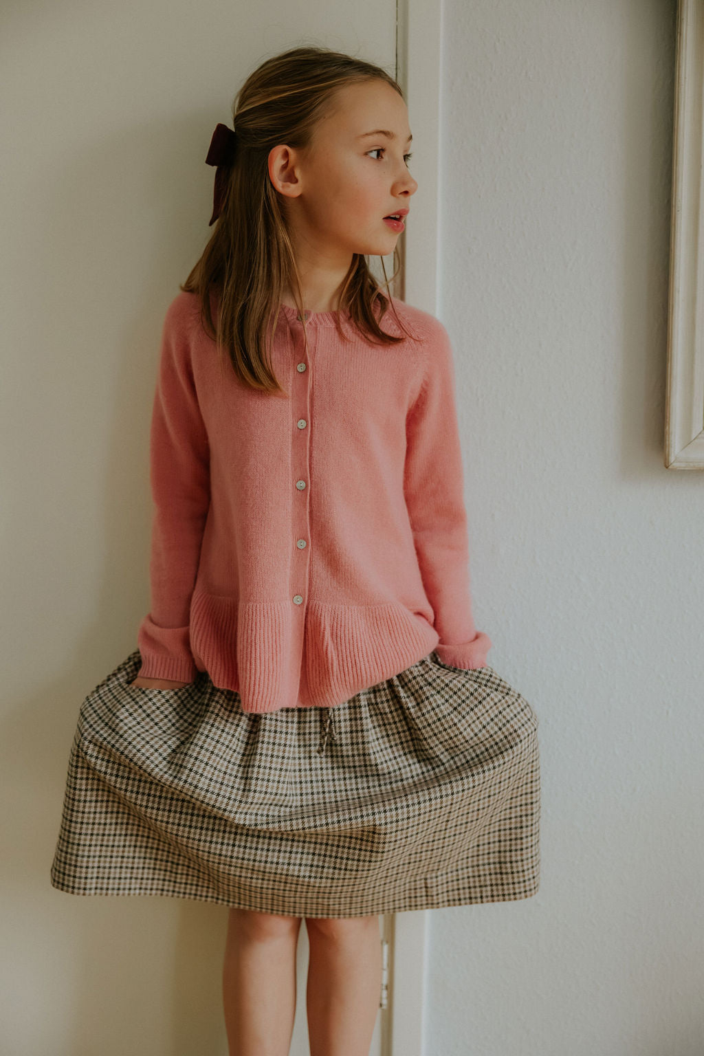 Girl wearing Lalaby Dagmar skirt for kids in tweedy check organic cotton
