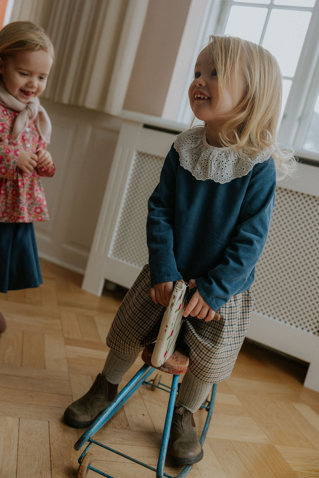 Girl wearing Lalaby Dagmar skirt for kids in tweedy check organic cotton