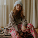 Girl wearing Lalaby Frankie pants for kids in berry betsy pink liberty organic cotton