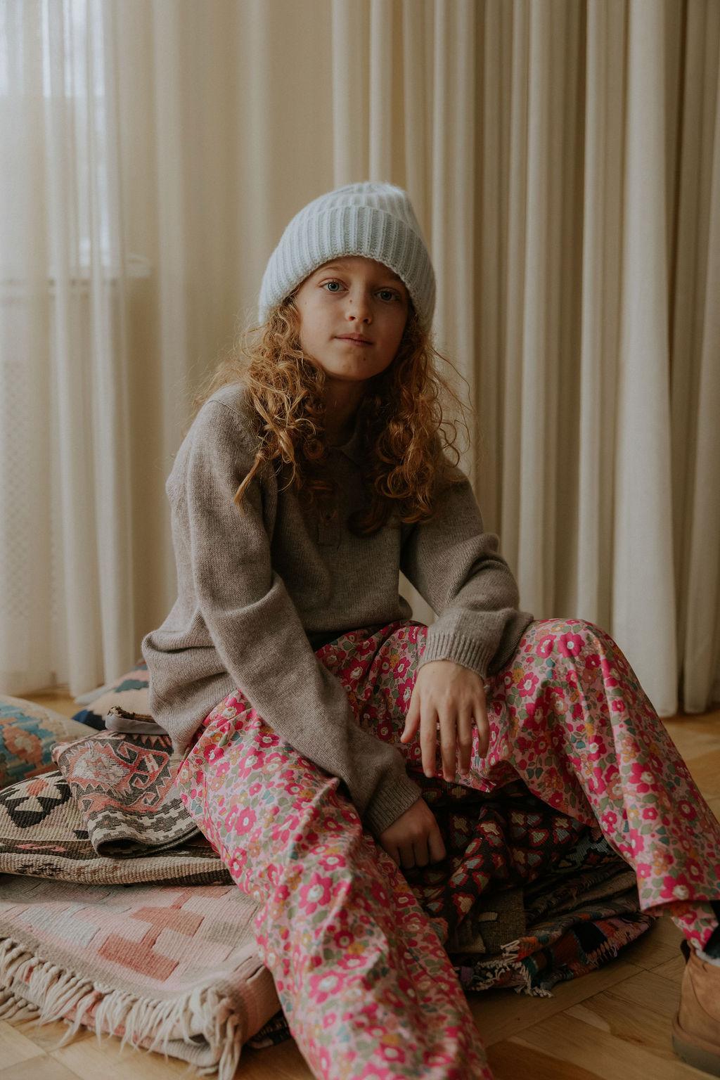 Girl wearing Lalaby Frankie pants for kids in berry betsy pink liberty organic cotton