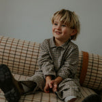 Boy wearing Lalaby Frankie pants for kids in tweedy check organic cotton