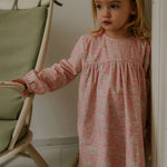 Girl wearing Lalaby Ines dress for kids in pink flower liberty cotton corduroy 