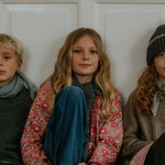 Girl wearing Lalaby Maxi pants for kids in whale blue cotton baby cord