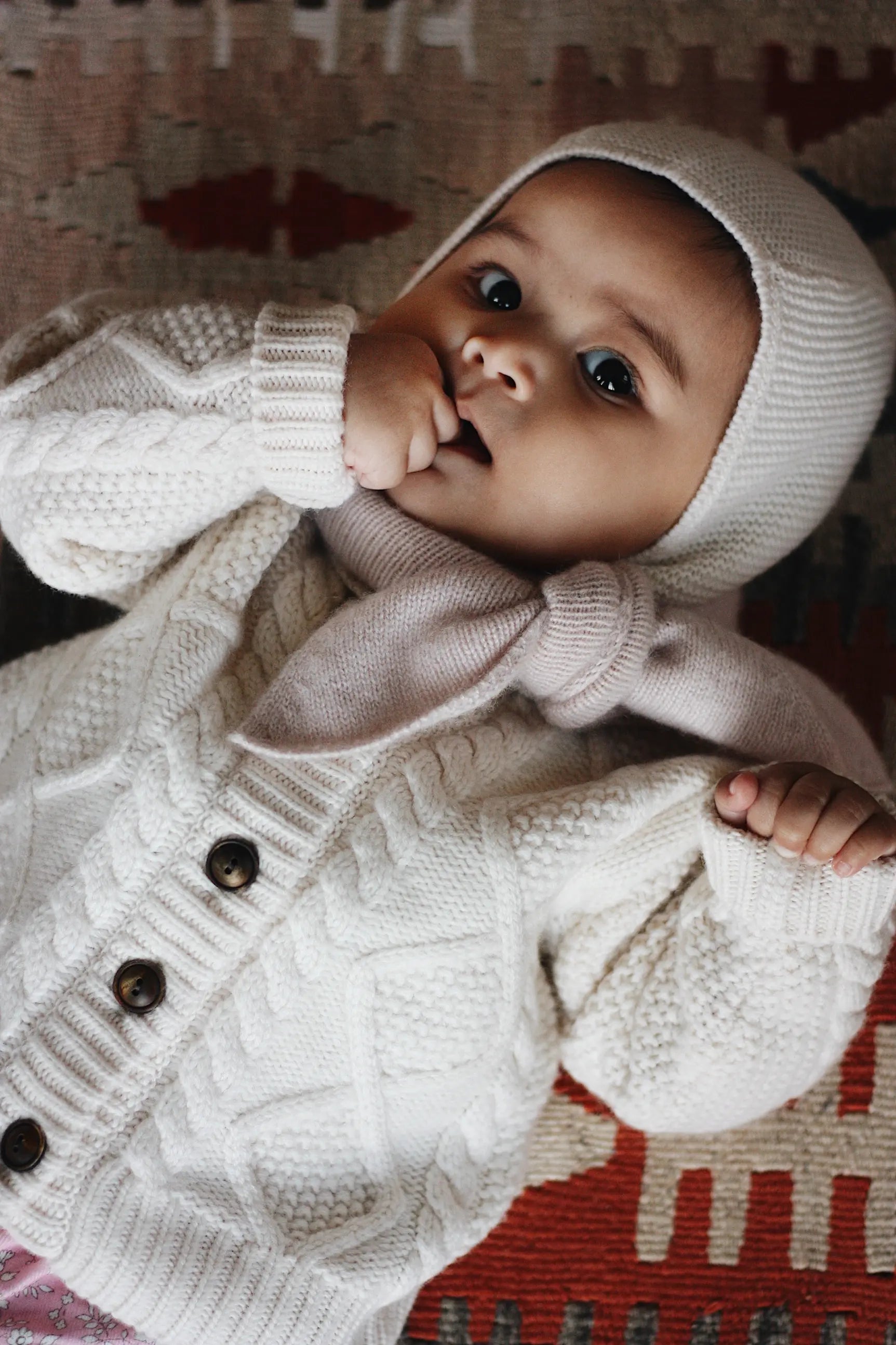 Baby girl wearing Lalaby Mumi balaclava for babies and kids in natural white merino wool