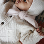 Baby girl wearing Lalaby Mumi balaclava for babies and kids in natural white merino wool