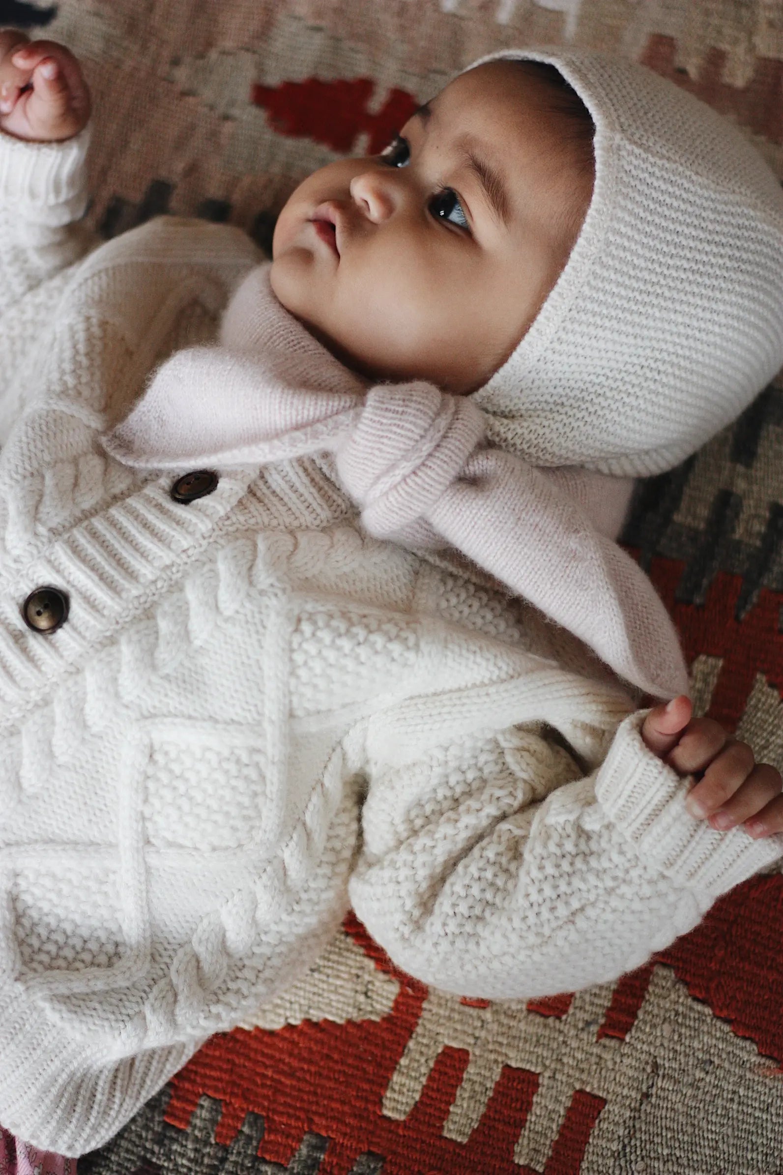 Baby girl wearing Lalaby Mumi balaclava for babies and kids in natural white merino wool