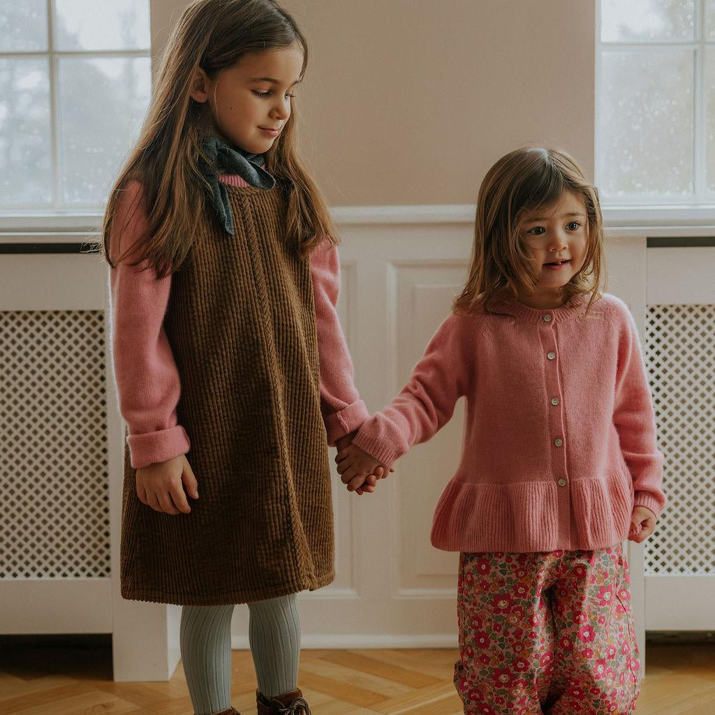 Girl wearing Lalaby Mumle dress for kids in cookie brown organic cotton mega cord