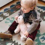 Baby boy wearing Lalaby Nomi baby cardigan in a millet brown baby wool, yak and cashmere blend
