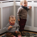 Baby boy wearing Lalaby Nomi baby cardigan in a millet brown baby wool, yak and cashmere blend