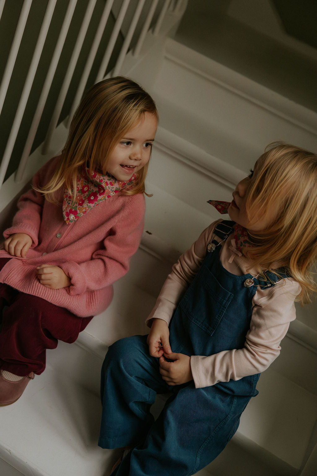 Girl wearing Lalaby Ole overalls for babies and kids in whale blue cotton baby cord