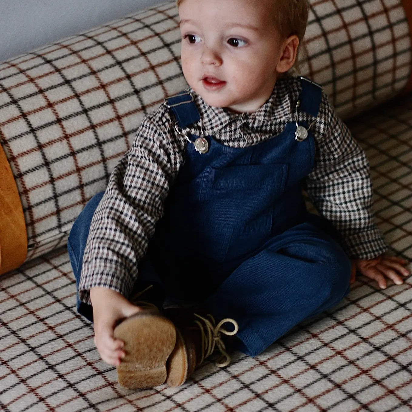 Baby boy wearing Lalaby Ole overalls for babies and kids in whale blue cotton baby cord